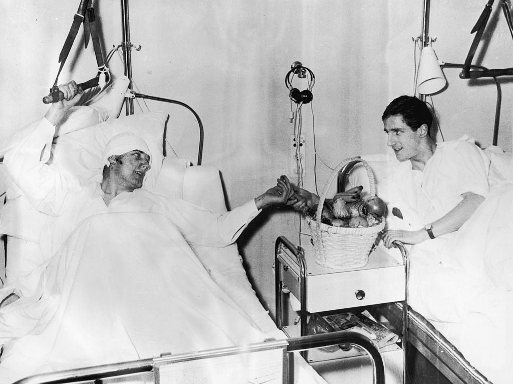 Manchester United footballers Dennis Viollet (left) and Albert Scanton share a basket of fruit in their ward at Isar Hospital Munich, 13th Feb 1958.