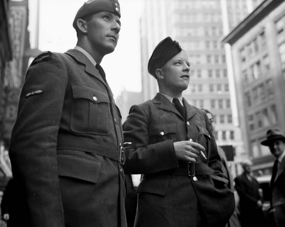 Two soldiers join the crowds as they expectantly wait for more updates.