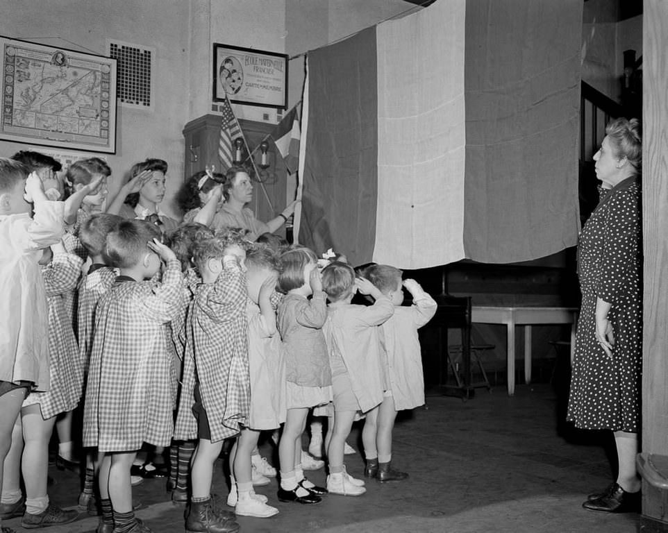 Children salute the French flag at a French school in Manhattan.