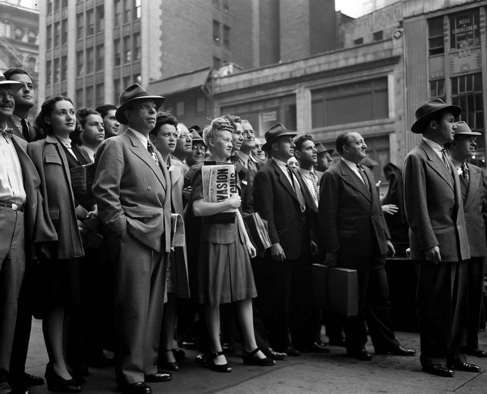 People gather in Times Square to watch the news ticker on the New York Times building.