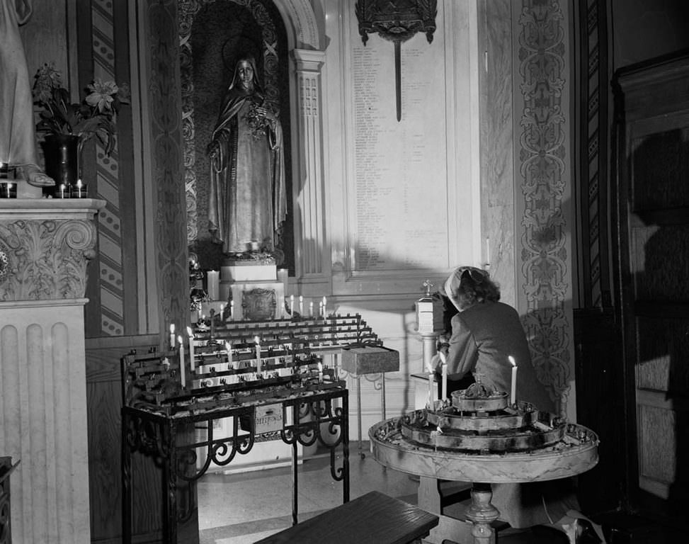 A woman prays at St. Vincent de Paul’s church on 23rd Street.