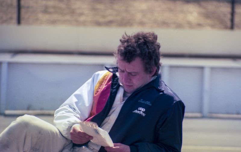 Jackie Oliver is reading his mail in the pits