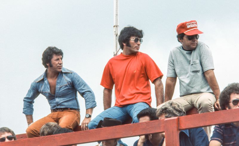 Mario Andretti, Johnny Parsons, and Larry McCoy await their turns for the driver introductions after qualifying was done