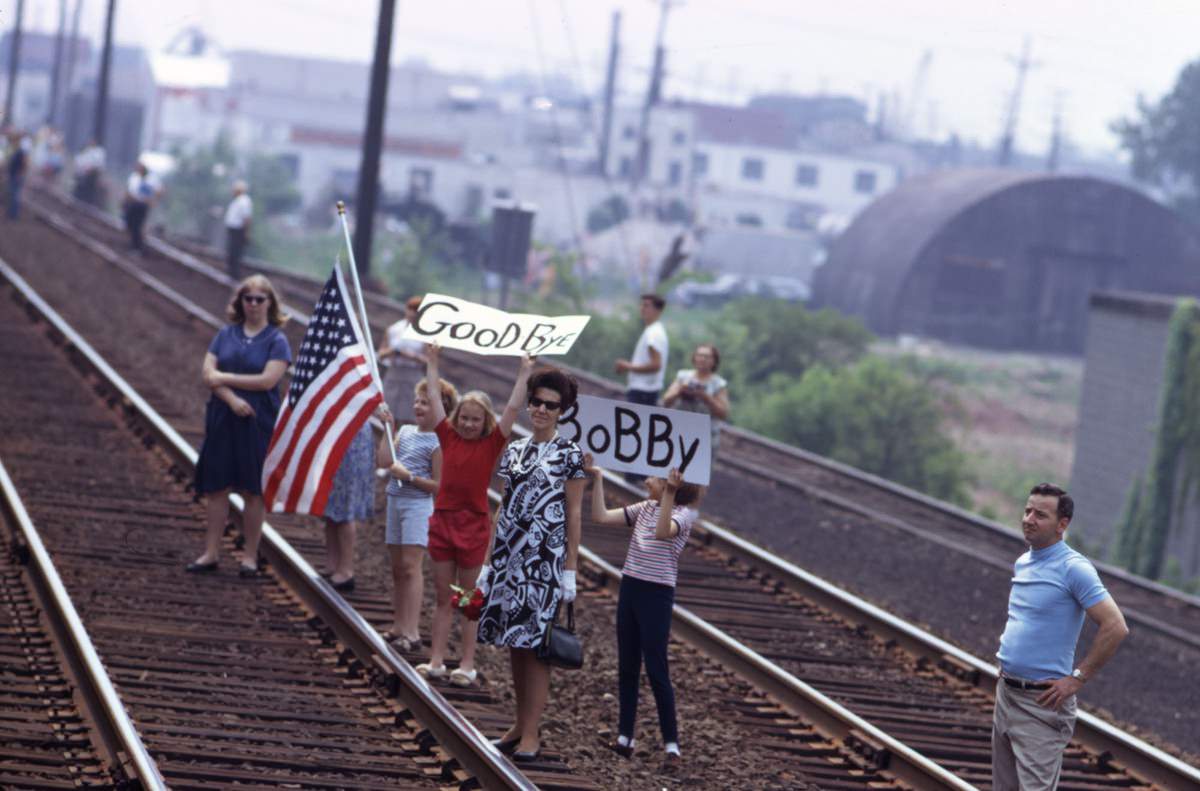 Mourners line the tracks to bid farewell to Robert F. Kennedy as his funeral train passes on its way from New York City to Washington, D.C., on June 8, 1968.