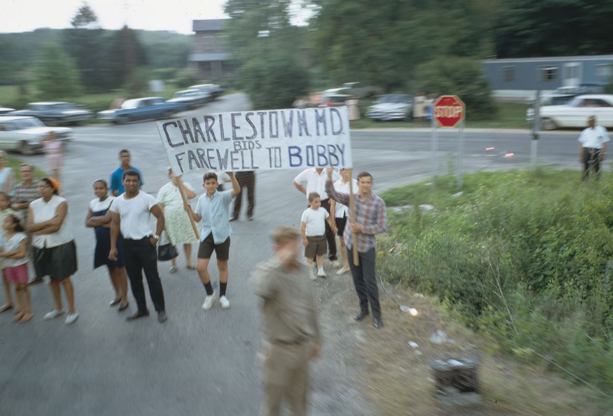 A sign is held up as the funeral train passes through Charlestown, Maryland, on June 8, 1968
