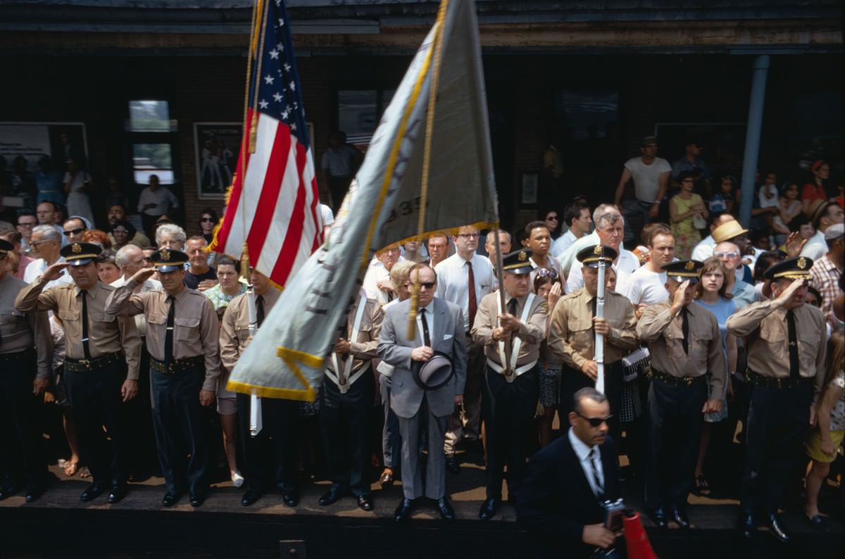 Members of the Elizabeth Firing Squad stand at attention among residents at the train station in Elizabeth, New Jersey, as the funeral train passes on June 8, 1968.