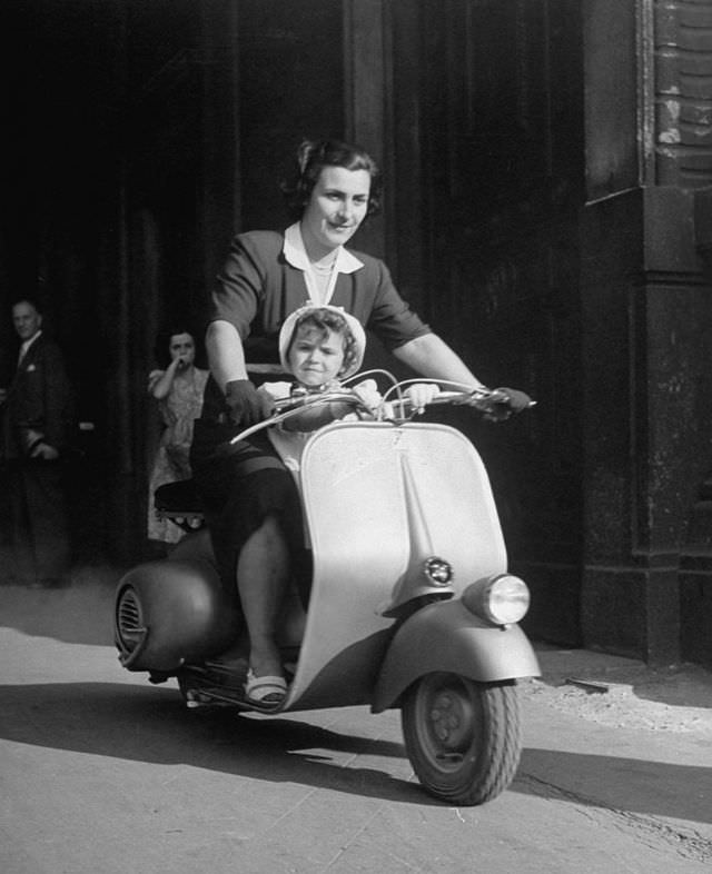 A mother and her baby on a Vespa.