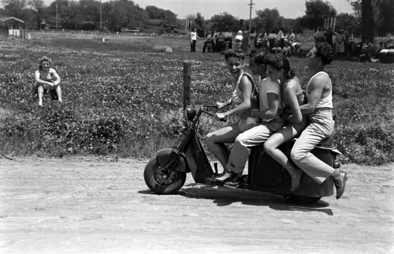 A group of friends on a scooter.