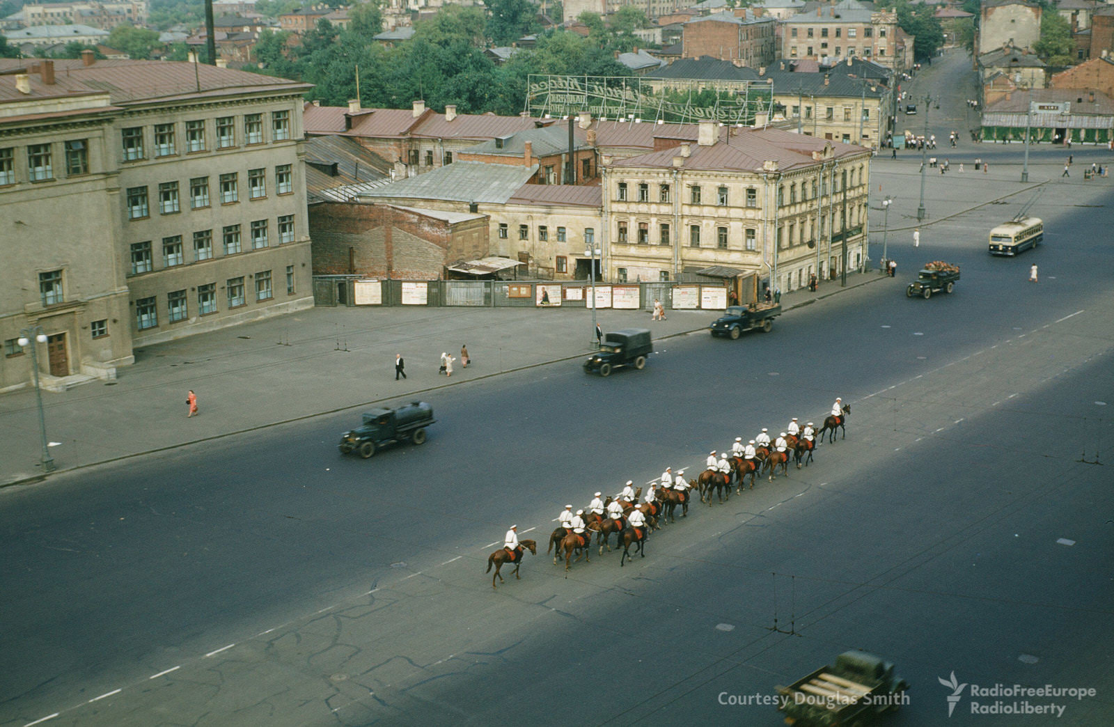 A line of horses take over the center lane, unknown location.
