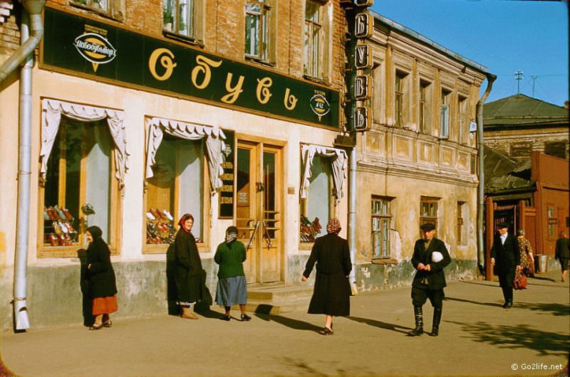 Soviet people passing by a store
