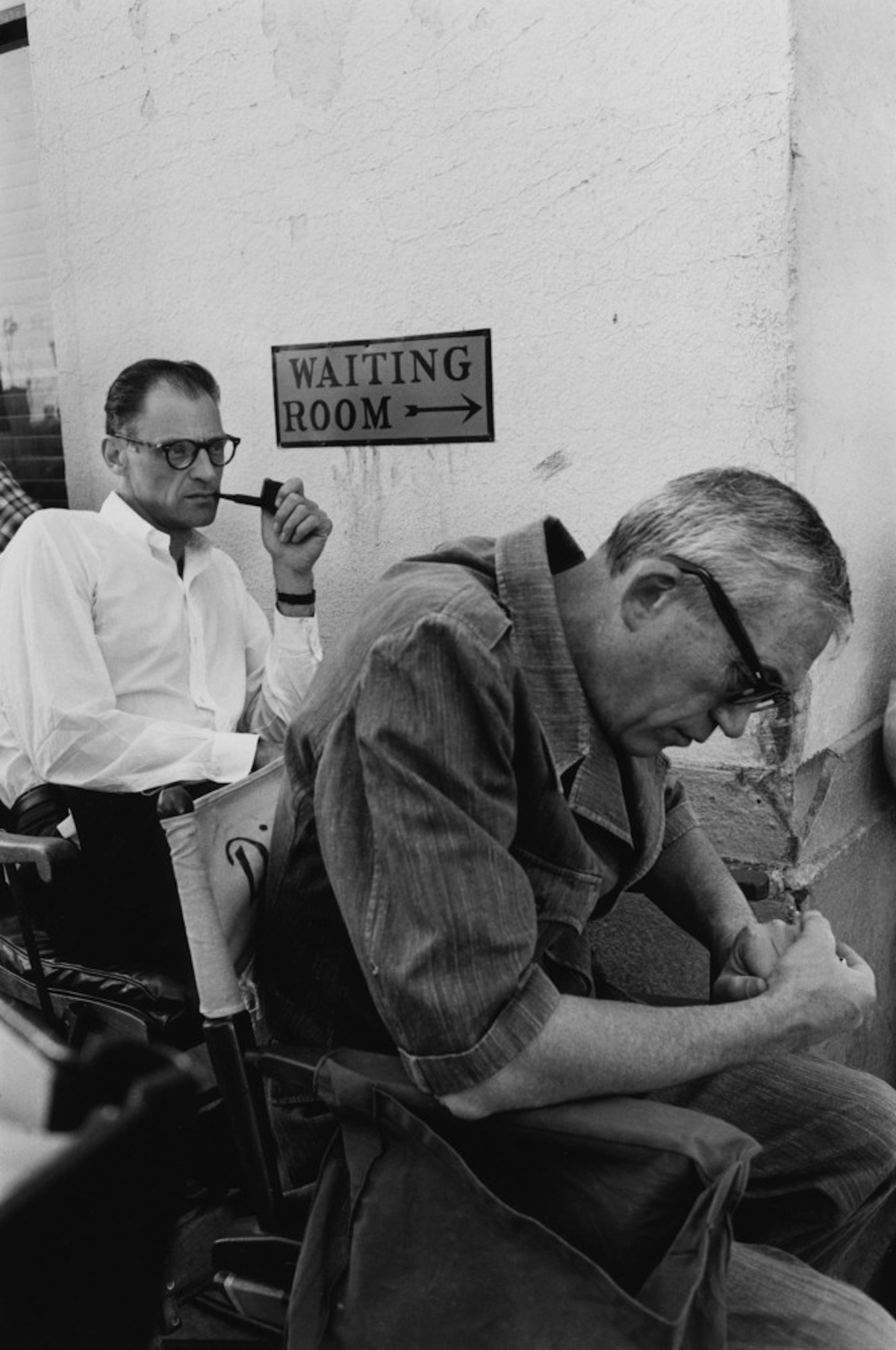 John Huston and Arthur Miller wait and brood over the next scene.