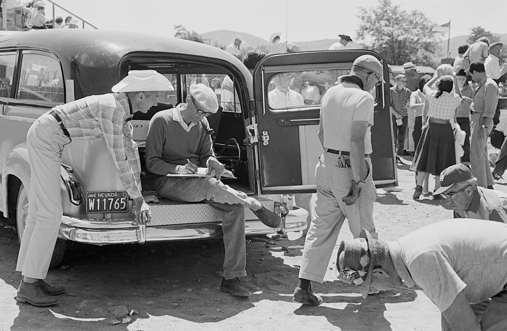 Arthur Miller (seated) and producer Frank E Taylor (left) in Nevada for the filming of 'The Misfits'