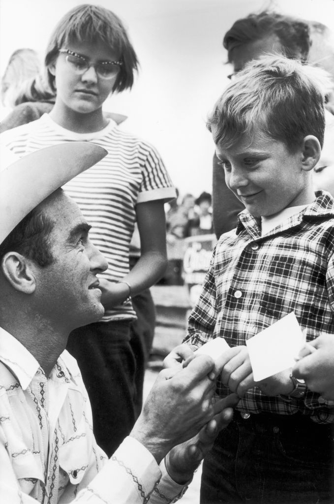 Montgomery Clift signs autographs for young fans during the filming of 'The Misfits'
