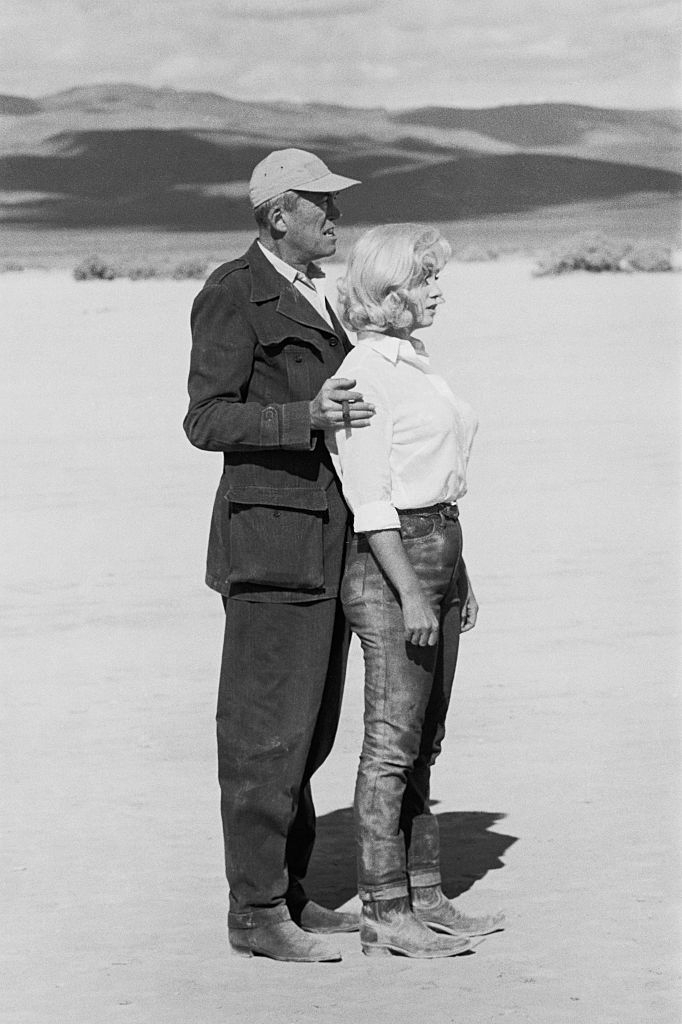 Director John Huston and Marilyn Monroe during the filming of 'The Misfits' on location in the Nevada Desert.