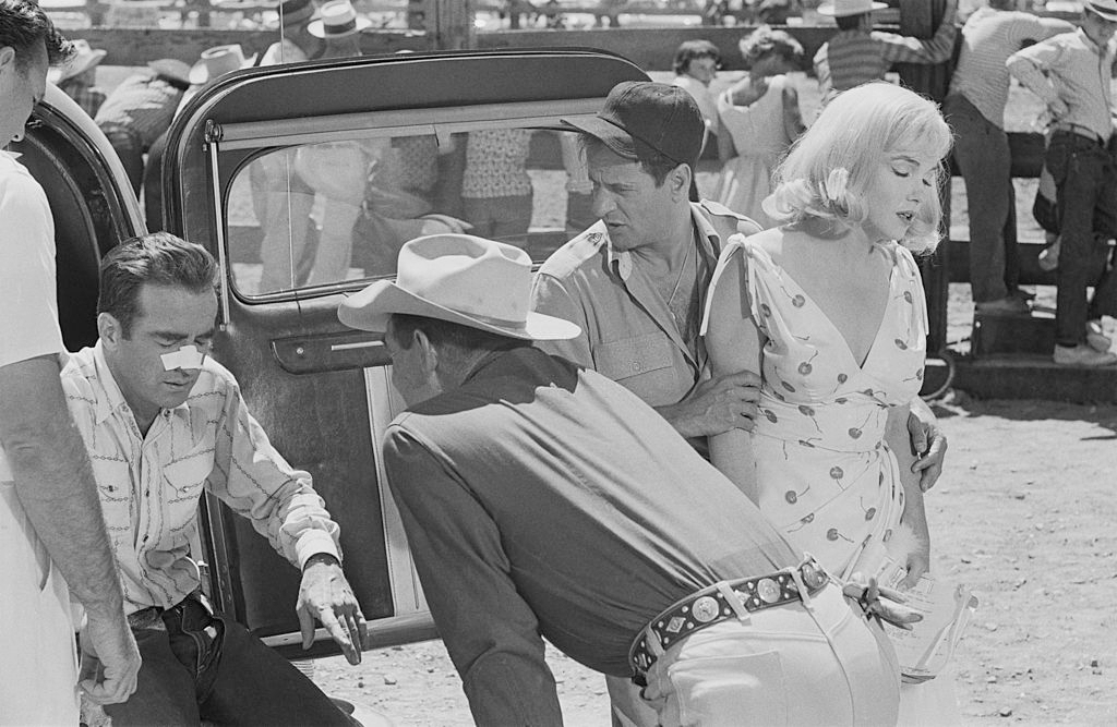 Clark Gable examines Montgomery Clift's broken nose whilst Eli Wallach looks after Marilyn Monroe in a scene from 'The Misfits'