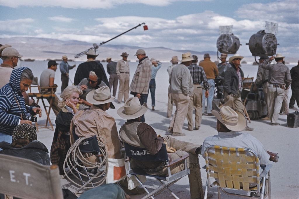 Marilyn Monroe sitting with her co-stars during the location filming of 'The Misfits' in Nevada.