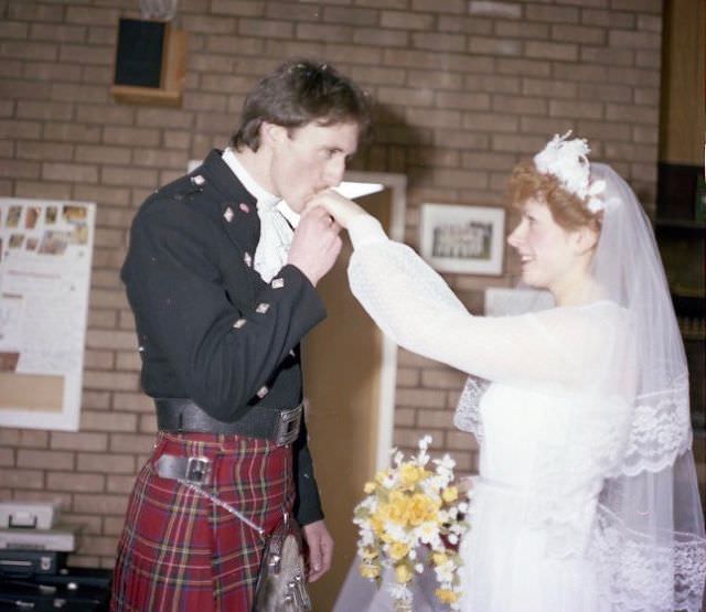 Groom kissing the bride's hands