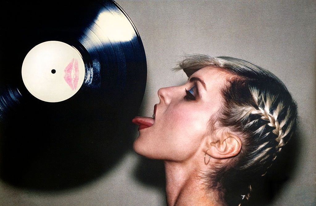 Debbie Harry licking a white label vinyl record which she had kissed, 1978.