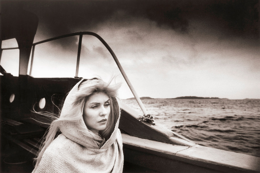 Debbie Harry pictured while travelling to the Scilly Isles to film the video for 'Island of Lost Souls', 1982.