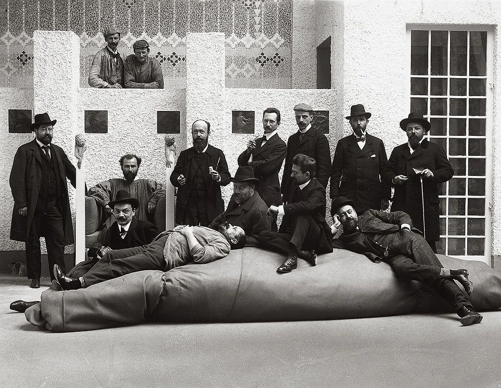 Group portrait of the artists of the Viennese Secession. Gustav Klimt in his pinafore and Kolo Moser sitting in front of Klimt. Austria, 1902.