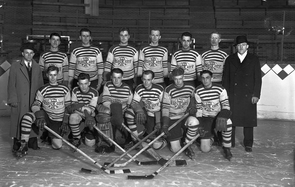 The amateur hockey team from the Flour City Coal and Oil company pose on the ice with their coaches in 1934.