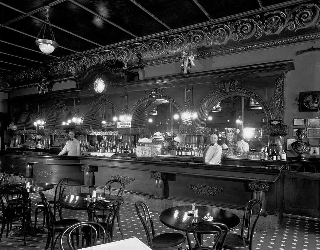 Two men stand behind the bar at Schiek's Cafe in Minneapolis, Minnesota. June 1, 1934.