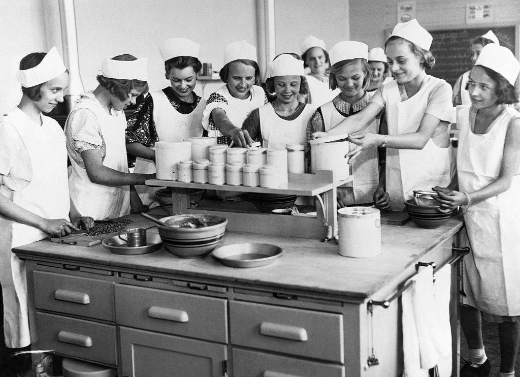 Students work on a cooking project in a Home Economics class in a Junior High School, 1935.