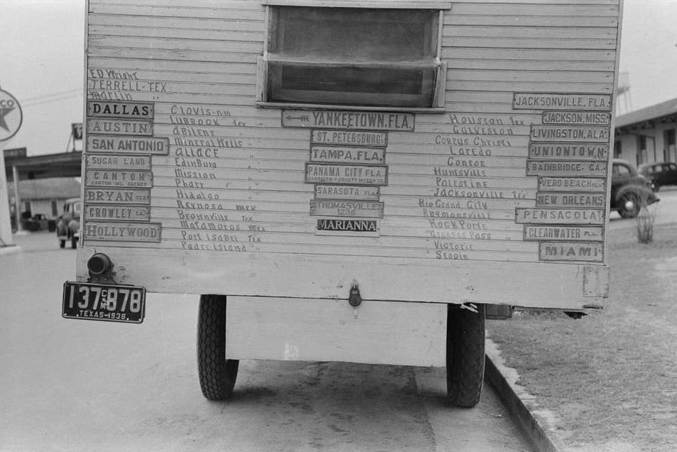 Truck home of traveler with plates from cities he has visited. Harlingen, Texas.