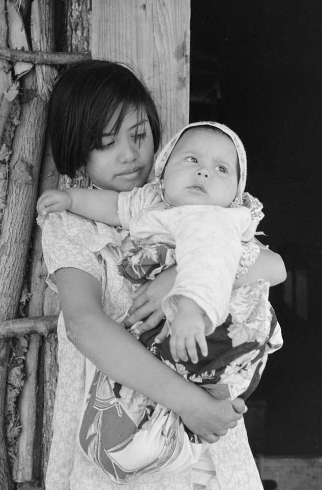 Mexican girl with baby sister in front of hut near Santa Maria, Texas, February 1939.