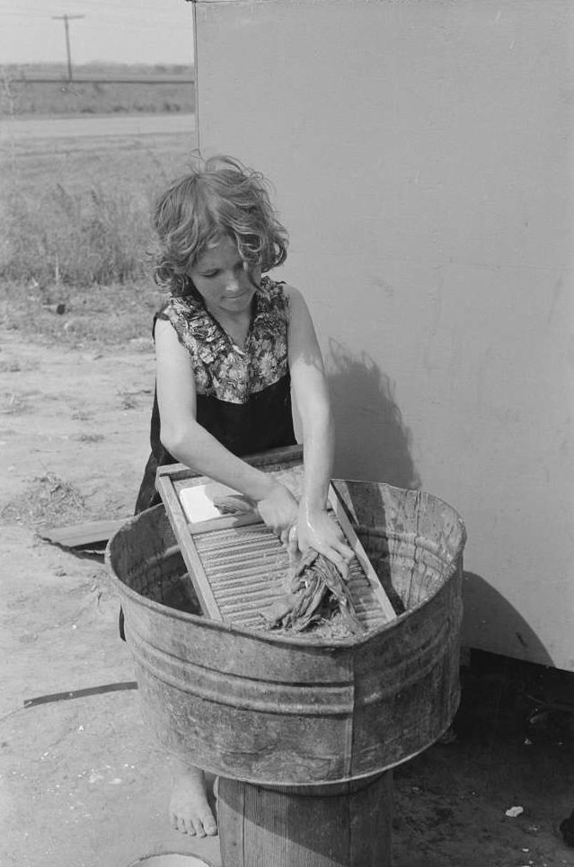 Twelve-year-old girl who keeps house in a trailer for her three brothers who are migrant workers, near Harlingen, Texas, February 1939.