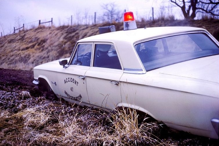 Police car is stuck in mud, Kansas City, 1963