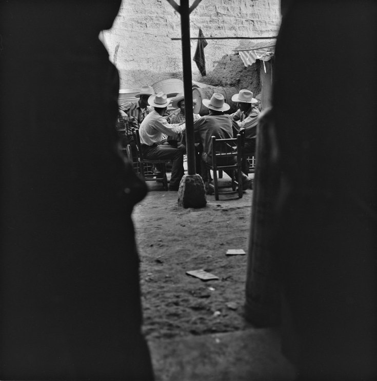 Men at a table in Batuc, 1963