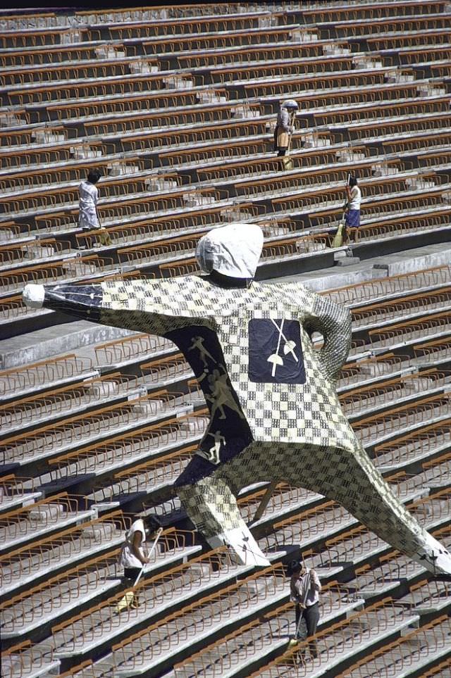 15-feet plastic fencer in en garde position erected in the stands at Aztec Stadium for Olympic Games.