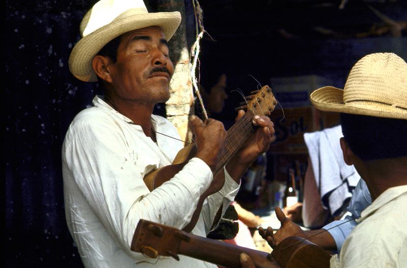 Mariachi singers strumming on ukuleles, 1968