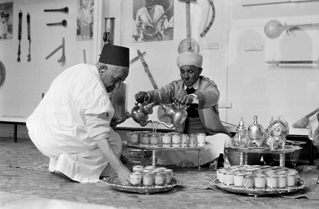 Two elderly men have mint tea in the medina of Rabat, Morocco in 1968.