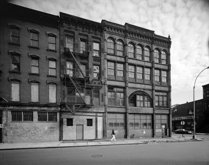 Boarded-up buildings and the Bedford Avenue faÃ§ade of the Smith Building, 123 South 8th Street, 1970s.
