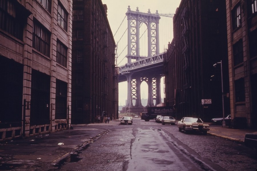 Manhattan Bridge tower in Brooklyn, New York City, framed through nearby buildings, in June of 1974.