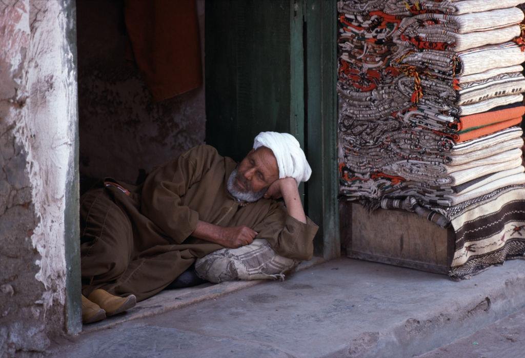 Fabric seller in the souk of Marrakech, in June 1977, Morocco.