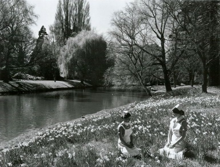 Nurses relaxing beside the river Avon, Hagley Park, Christchurch, September 1970
