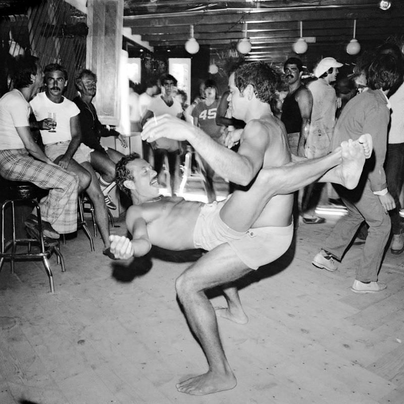 The dancing gets underway as these topless revellers display their acrobatic prowess