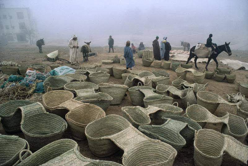 Market selling woven carrying basket for donkeys, traditional method of hauling goods, 1984.