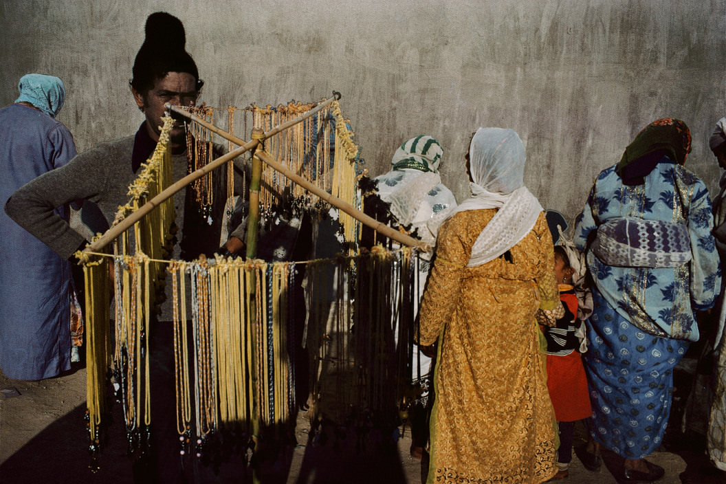 Merchants selling necklaces during the Moussem, traditional feast of the month of December, Meknes, 1988.