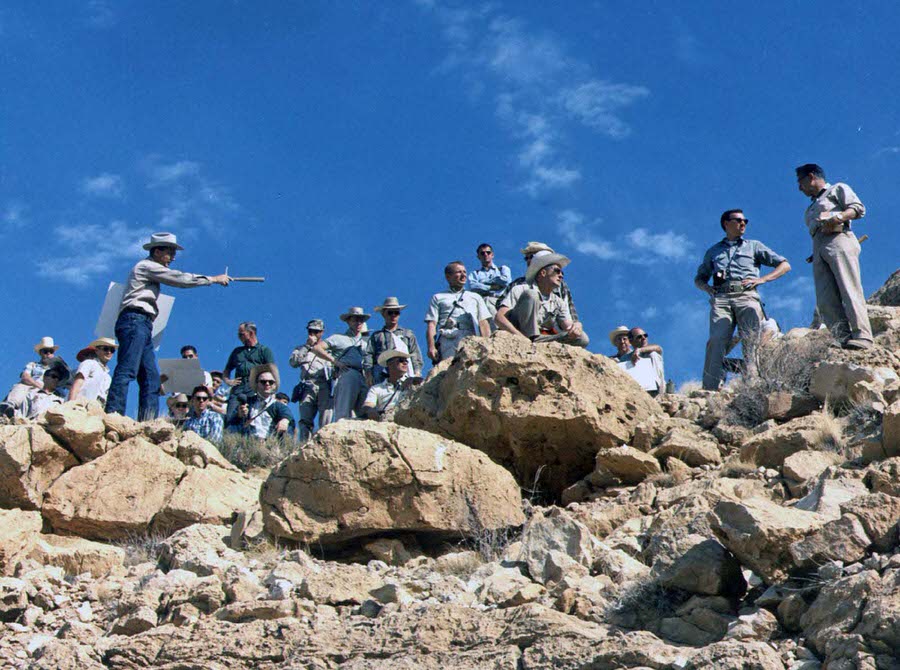 The astrogeologist Gene Shoemaker describes the geology of the rim ejecta of Arizona’s Meteor Crater to a large group of astronauts during a field trip in May 1967.
