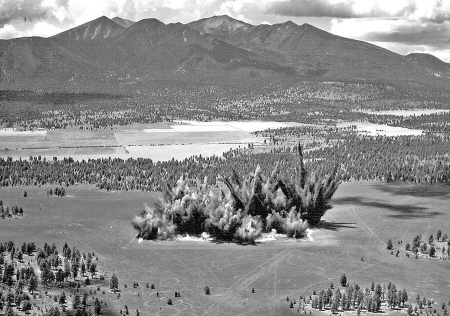 Explosions send dirt into the sky during the construction of Cinder Lake Crater Field on July 27, 1968.