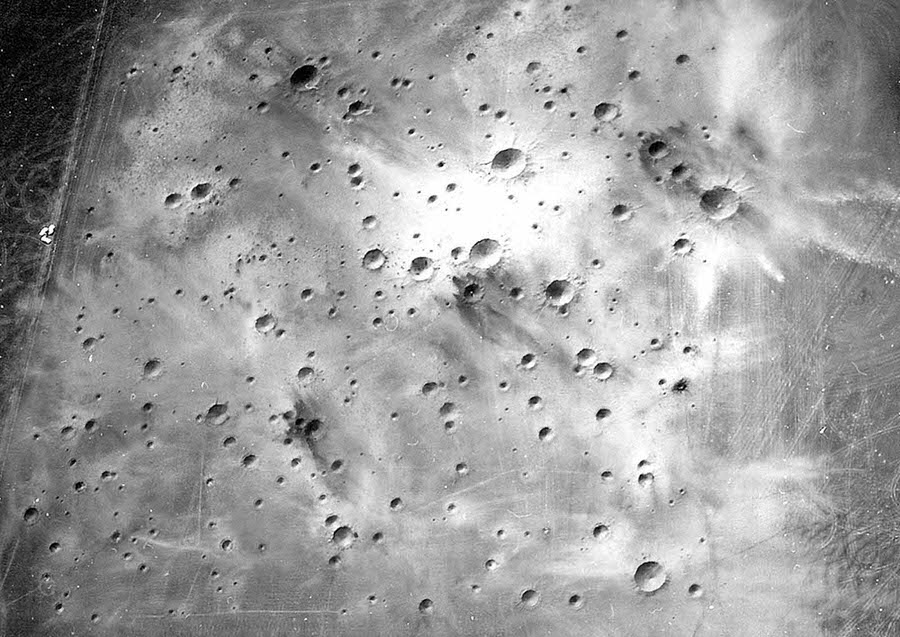 A post-explosion aerial view of the completed Cinder Lake Crater Field showing very light ejecta caused by excavation of clay beds immediately below black basaltic cinders.