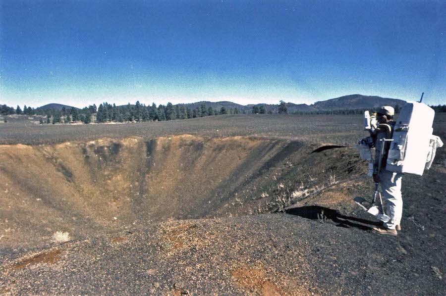 The astronauts Harrison Schmitt and Gene Cernan view a crater within the Cinder Lake Crater Field.