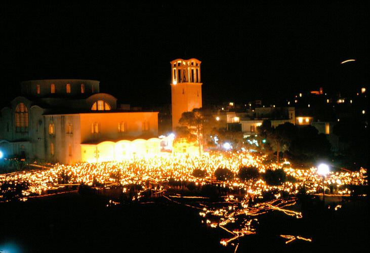 Easter at Agio Thomas as people leave the church with their candles.