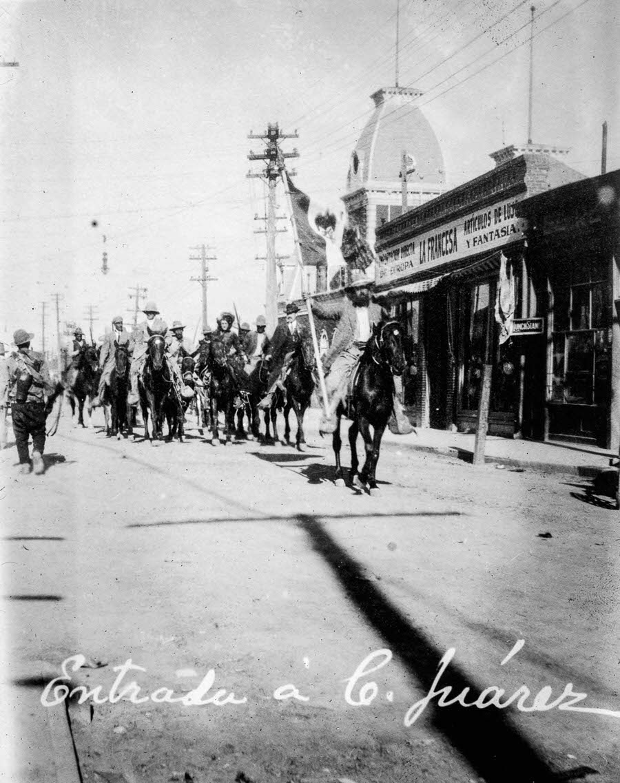 Revolutionary forces march into Ciudad Juarez after the surrender of federal forces.