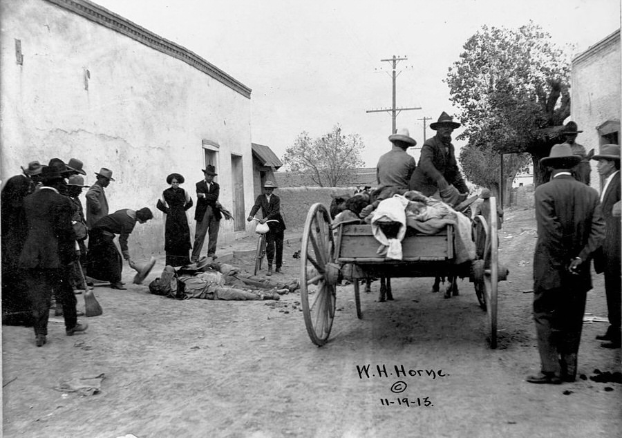 A cart of rebels collect and identify the deceased  bodies in the street during the Battle of Ciudad Juasrez.