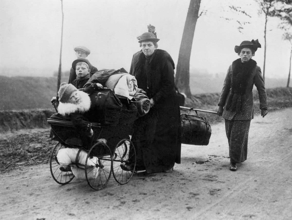 Belgian refugees carry their belongings ahead of invading troops through Northern France, 1914.